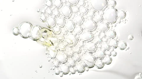 Liquid bubbles, fluid flow. Essential oil driping on a surface. Stock Footage 305073115