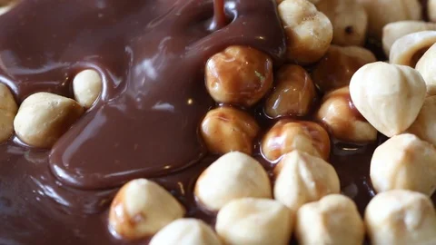 Liquid Chocolate Covers Hazelnuts Stock Footage 125909639