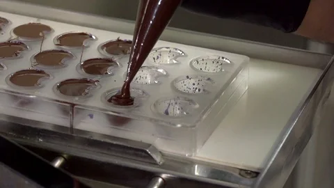 Liquid chocolate in a mold Stock Footage 101524786