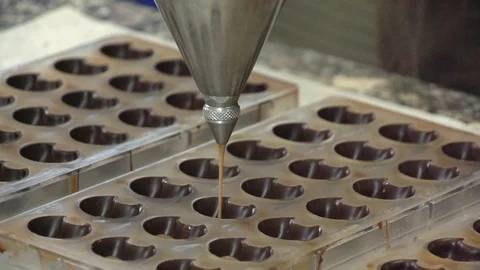 Liquid chocolate in a mold Slowmotion Stock Footage 101525474