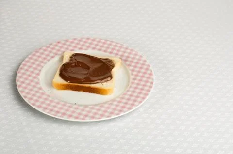Liquid chocolate on a slice of bread Stock Photos
