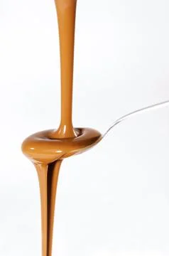 Liquid chocolate on spoon Stock Photos