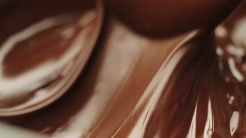 The liquid chocolate is stirred with a spoon Stock Footage 161077242