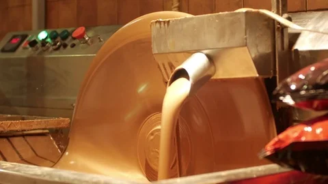 Liquid chocolate Stirring with pre-made bars of chocolate, tempering it, which Stock Footage 75989432