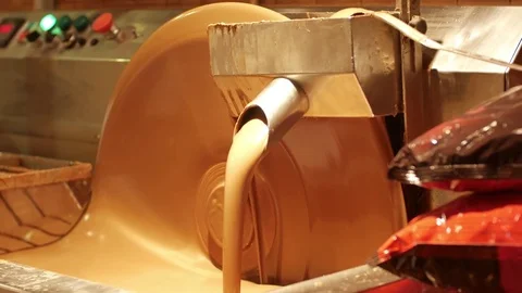 Liquid chocolate Stirring with pre-made bars of chocolate, tempering it, which Stock Footage 76142979