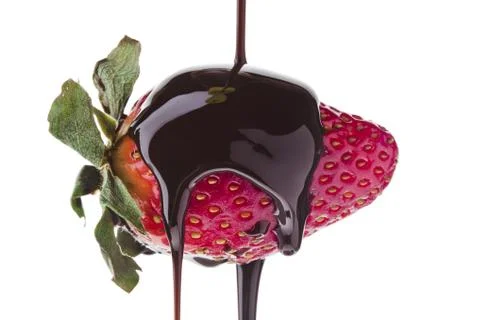 Liquid chocolate on strawberry Stock Photos