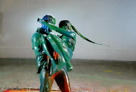 Liquid color paint falling over a couple Fotos Stock