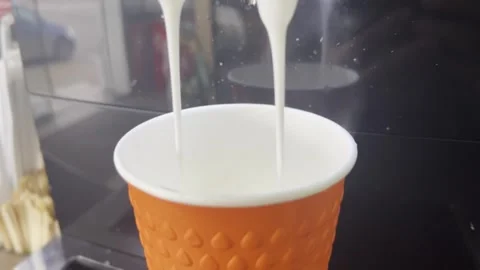 Liquid from a cup being poured into a coffee machine 스톡 동영상 271263610