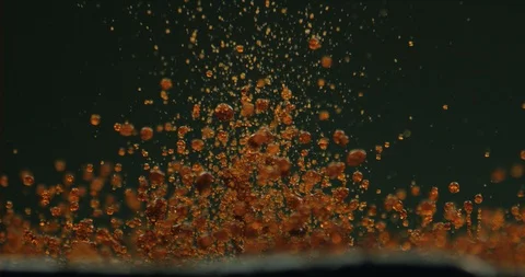 Liquid dancing from the vibrations of a speaker in slow motion Stock Footage 97816163