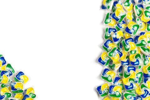 Liquid dishwashers capsules, background of all-in-one capsules with laundry Foto stock
