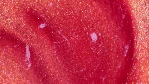 Liquid with dissolved particles of red candurin and bubbles slowly moves and shi Video stock 306073983