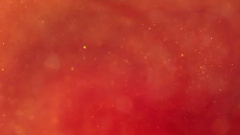 Liquid with dissolved particles of red orange candurin and bubbles slowly moves  Stock Footage 306074222