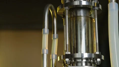 The liquid is distilled in a diopter with a yellow background fast close up Видео 185512841
