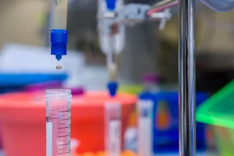 Liquid drippig through a filter column Stock Photos