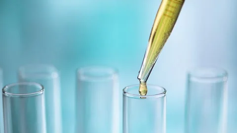 Liquid dripping from pipette into test tubes. Video stock 274444674