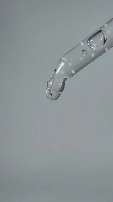 Liquid dripping slowly from the tip of the serum pipette Stock Footage 329872811