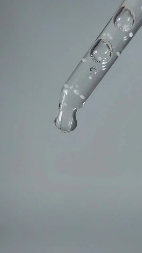 Liquid dripping from the tip of the serum pipette Stock Footage 329872729