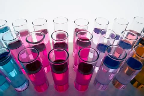 Liquid drop falling into test tubes Stock Photos