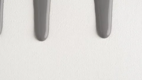 Liquid drops of grey paint color flowing on the white surface. Macro shot o.. Stock Footage 250163642