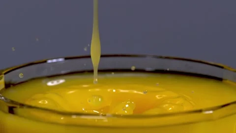 Liquid effect.  Orange Juice poured into a glass, detail, 2000 fps slow motion Stock Footage 299735131