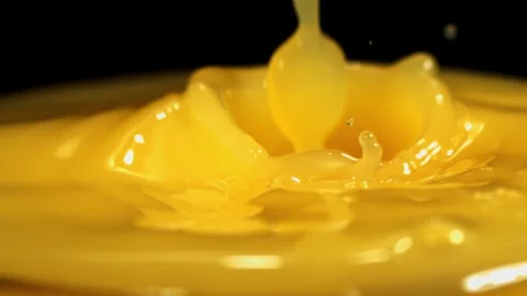 Liquid effect.  Orange Juice surface with pour, detail, 2000 fps slow motion Stock Footage 299735141