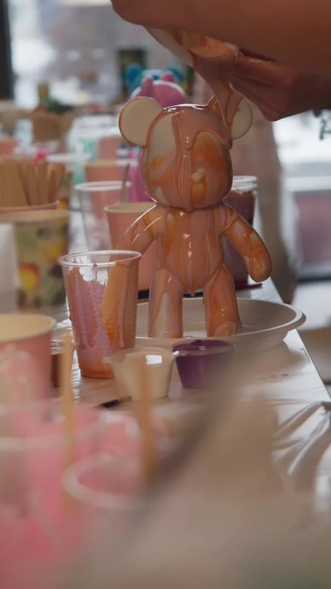 Liquid epoxy paint flows beautifully over the figurine as it is created during Stock Footage 306589035