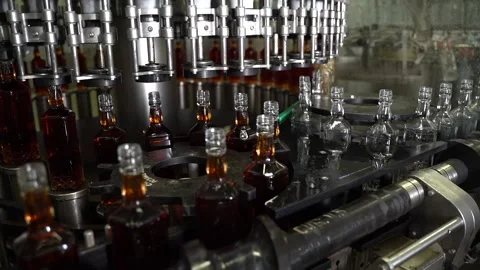 Liquid filling and bottle capping machine on alcohol beverage factory. Stock Footage 197474693