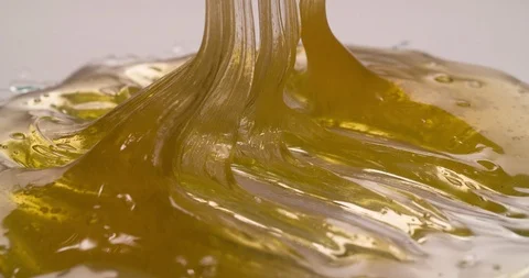 Liquid Flowing Caramel on white surface Macro Closeup Stock Footage 108815621