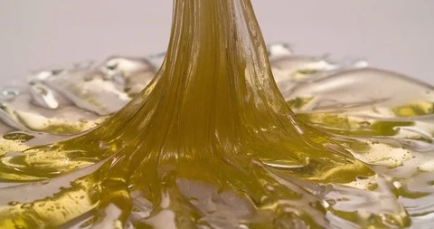 Liquid Flowing Caramel on white surface Macro Closeup shot Stock Footage 108815794