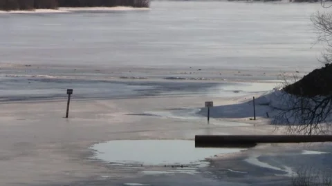 Liquid flows from the pipe into the frozen river in winter. Stock Footage 150122812
