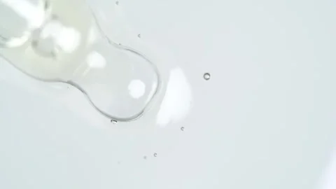 Liquid fluid transparent gel or serum on a white surface. Pipette with cosm.. Stock Footage 269024072