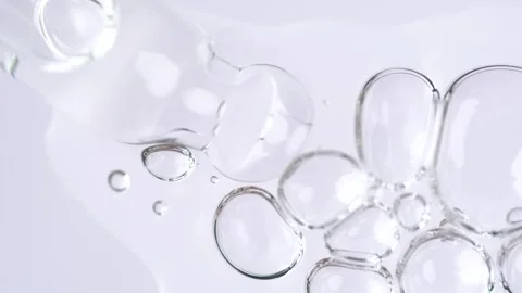 Liquid fluid transparent gel or serum in pipette drips on a white surface. .. Stock Footage 271130945