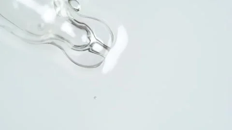 Liquid fluid transparent gel or serum on a white surface. Pipette with cosm.. Stock Footage 274547425