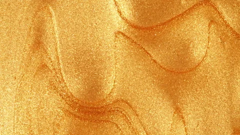 Liquid Gold Motion On The White Background. Macro Shot of Glitter Fluid Metallic Stock Footage 270936005