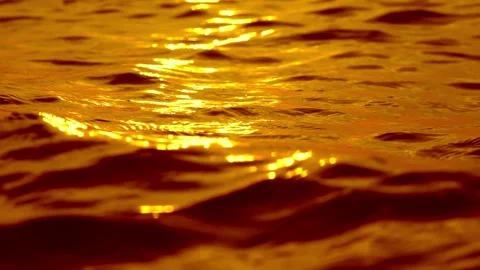 Liquid gold ocean waves with sun glitter in golden hour Stock Footage 336629158