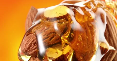 Liquid honey flows over nuts. almonds with honey close up. Stock Footage 242490105