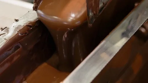 Liquid hot chocolate on the confectionery conveyor Stock Footage