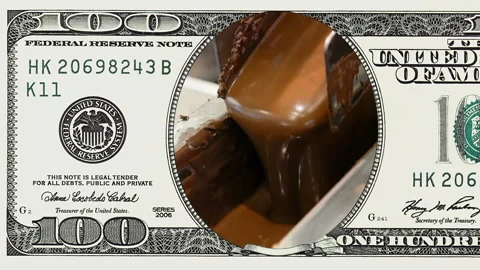 Liquid hot chocolate in frame of 100 dollar bill Stock-Footage 97600282