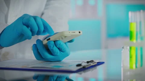 Liquid. Laboratory assistant researcher in protective gloves uses a modern s Stock Footage 261448368
