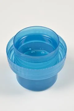 Liquid Laundry Detergent in Blue Measuring Cap Stock Photos