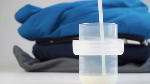 Liquid laundry detergent is poured into a measuring cap Stock Footage 152617930