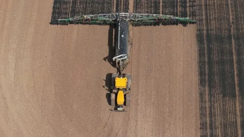 Liquid manure fertilizer application by tractor in agricultural field. Precision Stock Footage 339342511