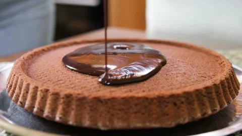 Liquid melted chocolate fall on homemade choco cake preparation,sweet food coook Stock Footage 232437441