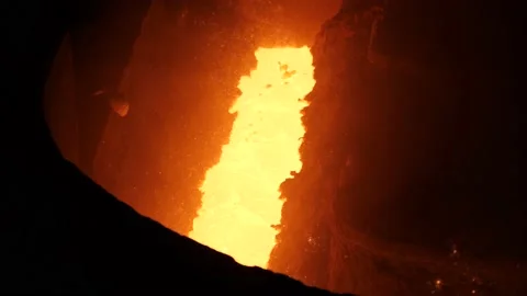 Liquid metal flows down the blast furnace chute Stock Footage 139736054