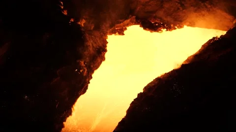 Liquid metal flows down the blast furnace chute. Stock Footage 139736091