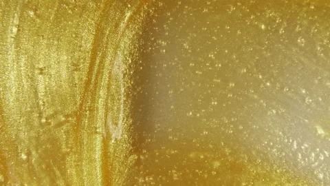 Liquid metallic gold background, texture. Sparkling yellow liquid paint flow Stock Footage