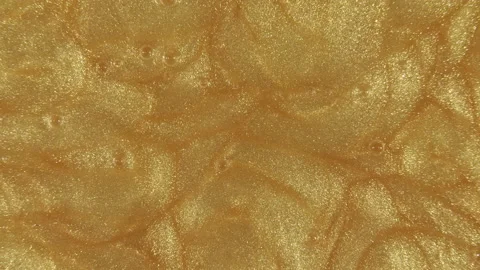 Liquid metallic gold background, texture. Sparkling yellow liquid paint flow Video stock 150486472