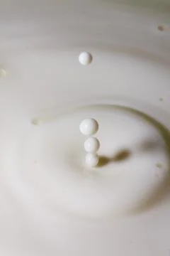 Liquid milk drop falling Stock Photos