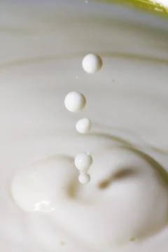 Liquid milk drop falling Stock Photos