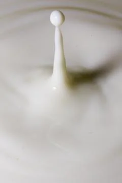Liquid milk drop falling Stock Photos